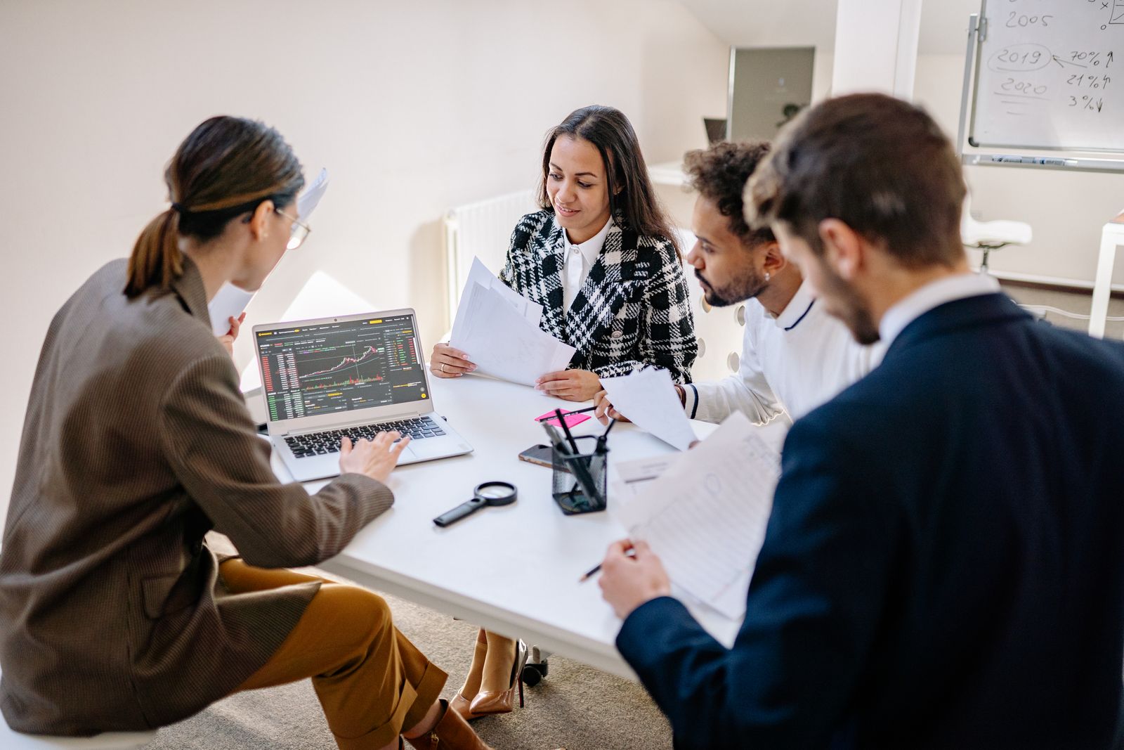 A cross-functional team working together around a laptop